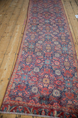 Herati design motif in royal blue and cherry red repeating along the vintage Tabriz runner.