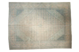 Distressed Tabriz carpet with ivory-beige field, dusty teal Herati medallion, and corner spandrels.