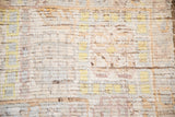 Textured pile of distressed Afghani Oushak rug, showing ivory, saffron, and faded periwinkle.