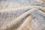 Textured pile of distressed Afghani Oushak rug, showing wear and subtle colors.