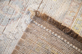 Textured hand-knotted wool pile and woven reverse foundation of the distressed Afghani rug.
