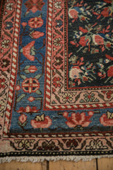 Detailed corner of a Persian runner with floral bouquets on blush, sky blue, and navy grounds.