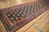 Long perspective of a Northwest Persian runner showing its floral field and sky blue border.