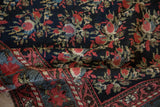 A folded view of an antique Northwest Persian runner revealing its dense, hand-knotted floral pile.