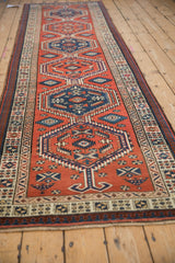 Angled view down the length of a vintage Serab runner with repeating geometric medallions.