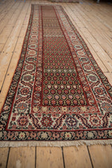 Vintage Malayer runner with a red serrated leaf border and intricate floral lattice field.