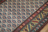 A vintage Persian runner's lattice shrub pattern against its gold and red serrated leaf border.