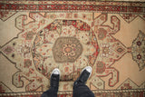 Detail of the double tiered palmette medallion on a distressed antique Karabagh runner.