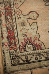 Corner detail of a tiered palmette and geometric border on a distressed antique Karabagh rug.
