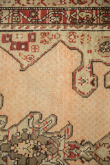 Close-up view of the low-pile texture on a Karabagh runner with charcoal and red motifs.