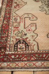 Close-up of the even wear and hand-knotted geometric motifs on a distressed Karabagh runner.