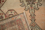Folded corner of an antique Karabagh runner showing the hand-knotted back and low pile.