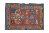 Vintage Heriz rug with a serrated double medallion in brick red, sky blue, and sand.