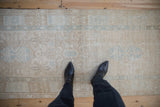 Distressed vintage Karaja rug runner showing faded ivory, beige, and powder blue geometric designs.