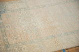 Distressed vintage Karaja runner pile with soft beige and faded blue hook and latch motifs.