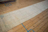Distressed Karaja runner with machine-bound edge, even wear, and soft ivory, blue patterns.