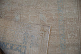 Distressed beige Karaja rug pile showing faded blue geometric patterns and tightly woven foundation.
