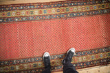 Antique Northwest Persian runner with pale ruby field of botehs and starburst, vine borders.