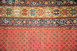 Antique Northwest Persian runner's red field with minor botehs and saffron yellow main border.