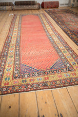 Antique Northwest Persian runner end, saffron yellow starburst border, ruby red field with sapphire motifs.