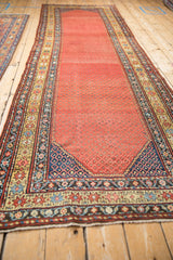 Detail of antique Northwest Persian runner showcasing madder field and intricate starburst, vine borders.