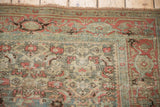 Reciprocating turtle samovar border in dusty slate blue and ruby red on a vintage Persian rug.