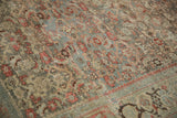 Detailed angled view of the distressed Bijar's Herati design with visible knot heads.