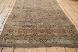 Perspective view of the vintage distressed Bijar rug, showcasing its time-softened Herati pattern.