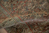 Dense hand-knotted pile and turtle border on a vintage Bijar rug, shown in a soft fold.