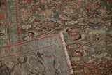Hand-knotted foundation and distressed pile shown on the corner of a vintage Bijar rug.