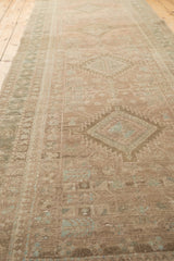 Lengthwise view of the vintage Serab rug runner with its muted, distressed geometric pattern.