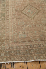 Reciprocating pawn motif and germinating plant border detail on a distressed vintage Serab runner.