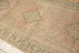 Detailed view of geometric blossoms and the low, even pile on a vintage Serab runner rug.