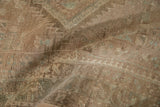 Close-up of a folded vintage Serab runner showing its low, evenly worn pile texture.