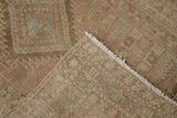 Close-up of the vintage Serab rug's hand-knotted foundation and worn, textured pile.