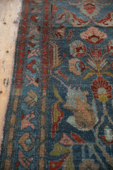 Distressed vintage Mehreban runner shows dusty denim blue field, burgundy serrated leaves, and faint foundation.
