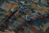 Close-up of vintage Mehreban rug showing distressed pile, blue, burgundy, and green leaf motifs.