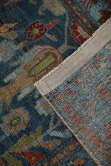 Distressed Mehreban runner detail: worn dusty denim blue pile with serrated leaves, revealing hand-knotted foundation.