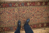 Antique Karabagh runner's Herati design and crab-style border viewed from a standing perspective.