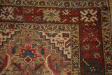 Burgundy crab-style floral border alongside the geometric camel-colored field of an antique Karabagh runner.