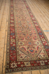 The repeating Herati design travels down the camel field of this long antique Karabagh runner.