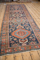 Vintage Karaja runner right border, featuring brick red floral patterns and navy field pinwheel blossoms.