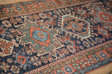 Persian Karaja runner's navy, brick red, and teal geometric medallion pattern.