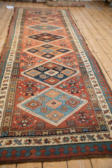 Vintage Serab runner with navy and camel diamond medallions, madder red field, pawn border.