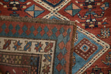 Vintage hand-knotted Serab runner edge with geometric madder red, blue, and ivory pawn design motif.