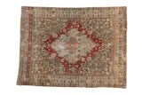 Vintage distressed Bijar square rug with a red geometric medallion on a dusty slate blue field with sand highlights.