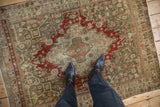 Overhead view showing the distressed, time-softened texture of a vintage Persian Bijar rug.