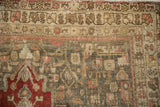 Close-up of the distressed Bijar rug showing even wear to the knot heads and border detail.