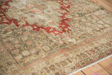 Angled view of a vintage Bijar rug's mostly even wear, with pile worn to the knot heads.