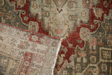 Detail of a vintage Bijar's folded corner, revealing the hand-knotted weave and distressed pile.